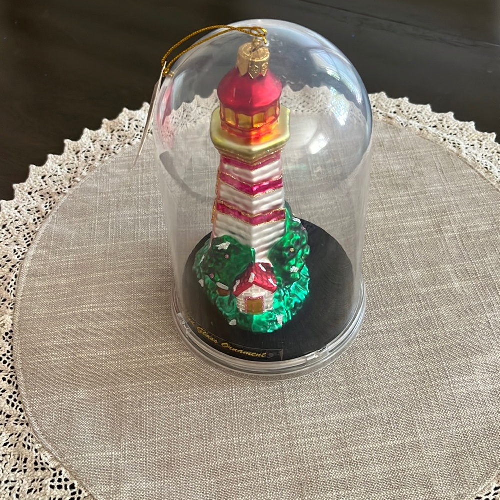 Handcrafted glass lighthouse ornament.
